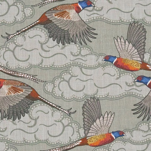 Pale blue-grey fabric with flying pheasants, cloud scrolls and rust, saffron and blue accents