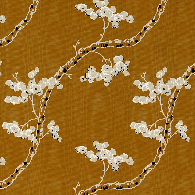 Gold ochre fabric with cream blossom branches, dark twig marks and a visible woven grain