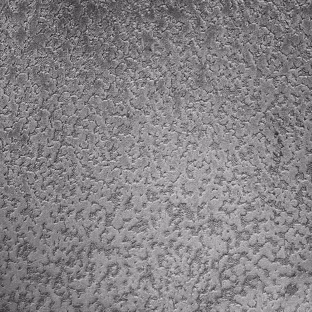 Cool seal-grey fabric with dense irregular mottling and tactile textured surface