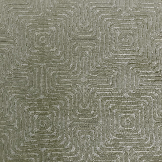 Muted sage-fern woven textile with raised tonal maze lines and square motifs