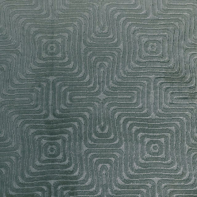 Muted forest-green woven fabric with tonal rounded-square maze pattern and textured surface