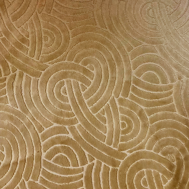 Warm bronze fabric with raised interlocking paisley and looping line motifs