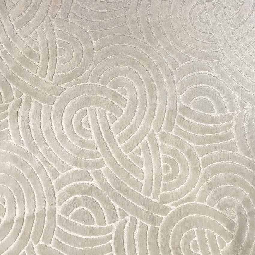 Pale oyster textile with raised interlocking paisley-like loops and a softly tactile surface
