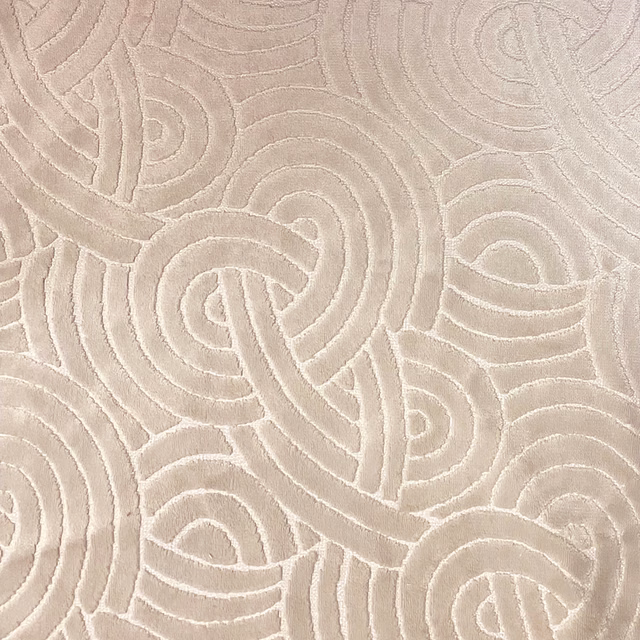 Warm taupe fabric with raised abstract looping lines and a softly plush texture