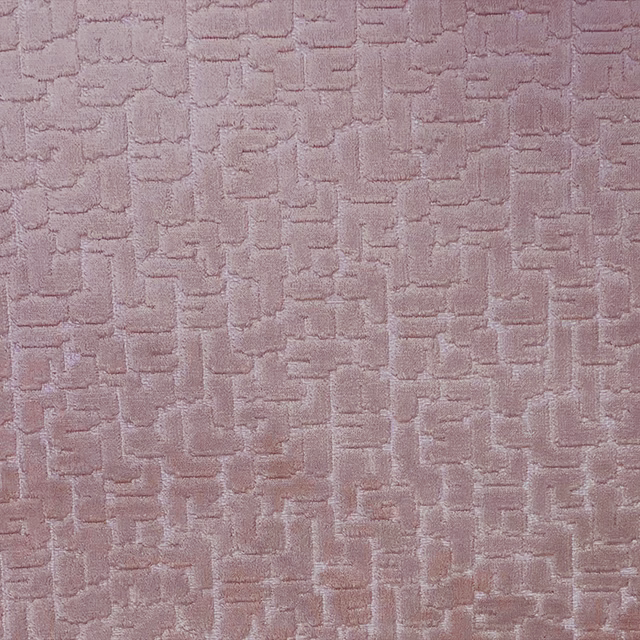 Dusty blush-pink textile with raised, broken geometric blocks and a softly napped surface