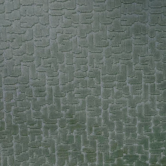 Muted forest green textile with raised irregular rectangular geometric texture