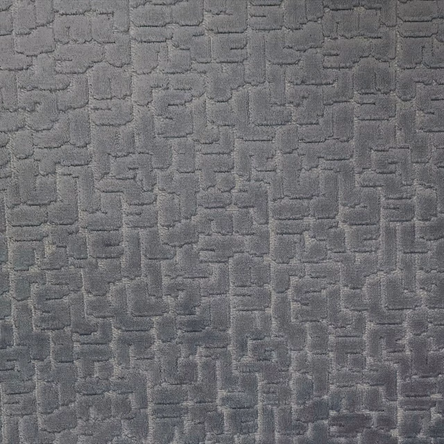 Close view of cool charcoal-grey fabric with raised interlocking rectangular texture