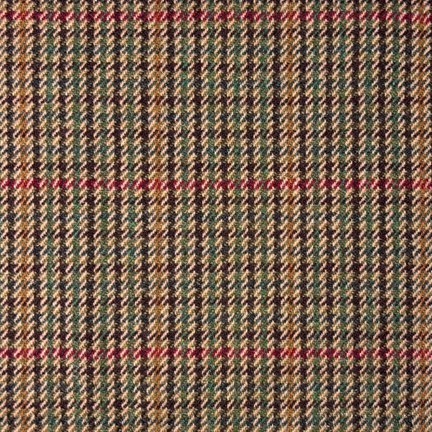 Close-up of beige tweed with dark green zigzags and muted red lines