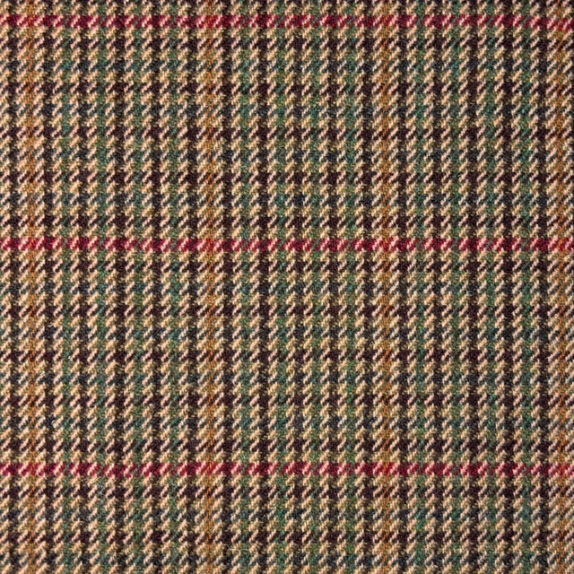 Close-up of beige tweed with dark green zigzags and muted red lines