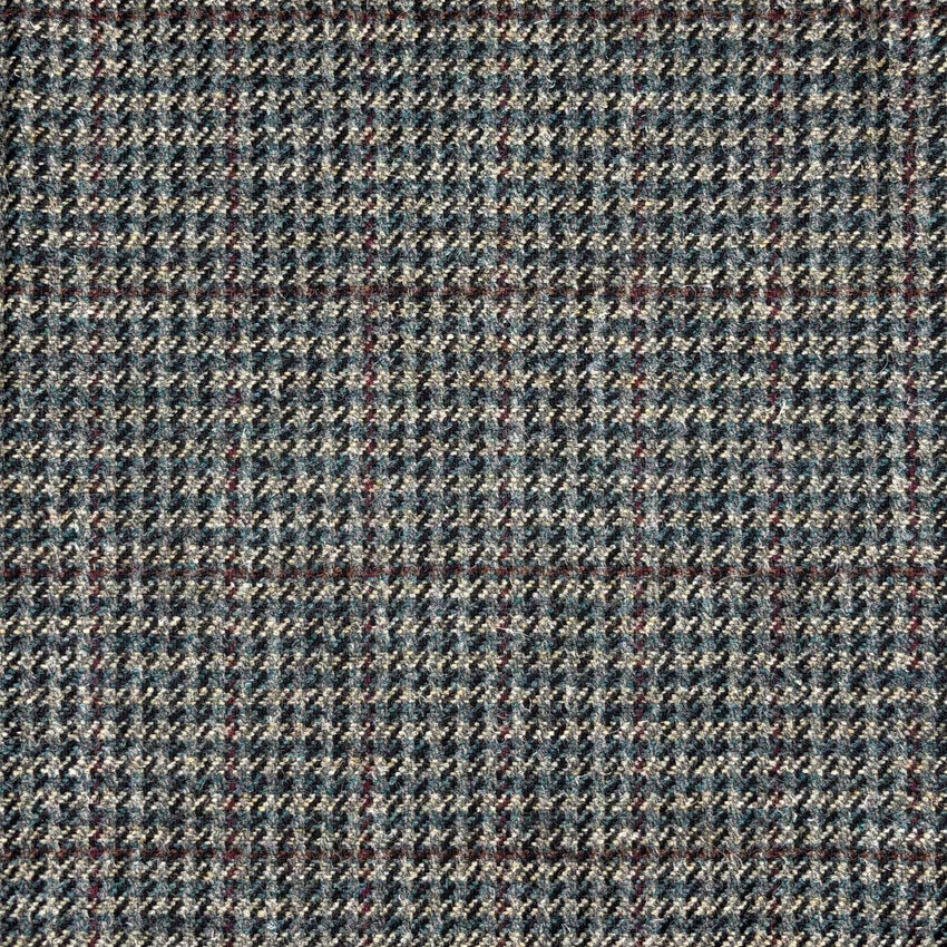 Blue-grey tweed with fine herringbone texture, cream flecks and rust accents