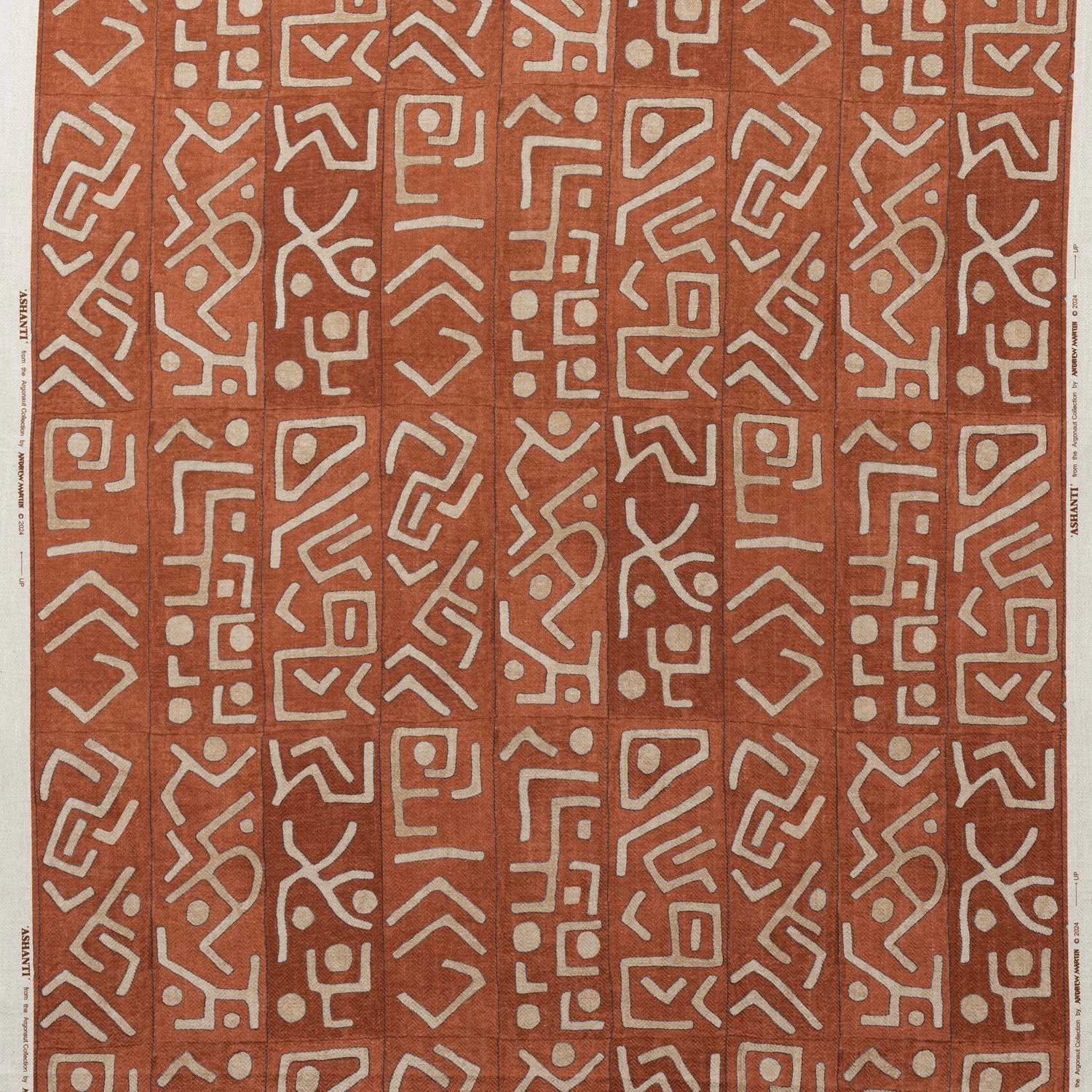 Warm brick-red textile with repeated chalk geometric maze motifs and visible weave
