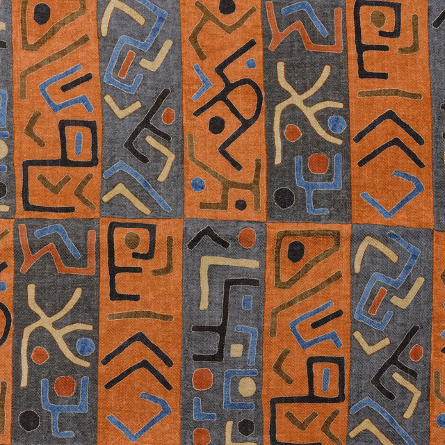 Rust brown geometric woven fabric with charcoal, blue, cream and red abstract motifs