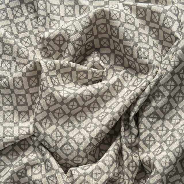 Stone-grey textile with charcoal linked diamond motifs and textured woven surface