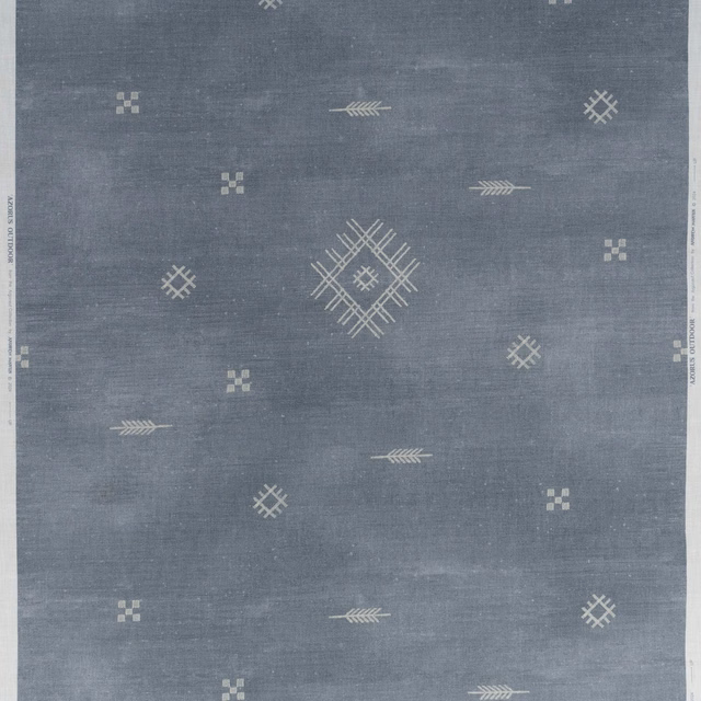 Muted denim blue-grey outdoor fabric with pale geometric diamonds, arrows and central lattice motif.
