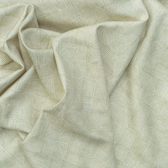 Pale lichen-green fabric with fine angular geometric lines in relaxed folds