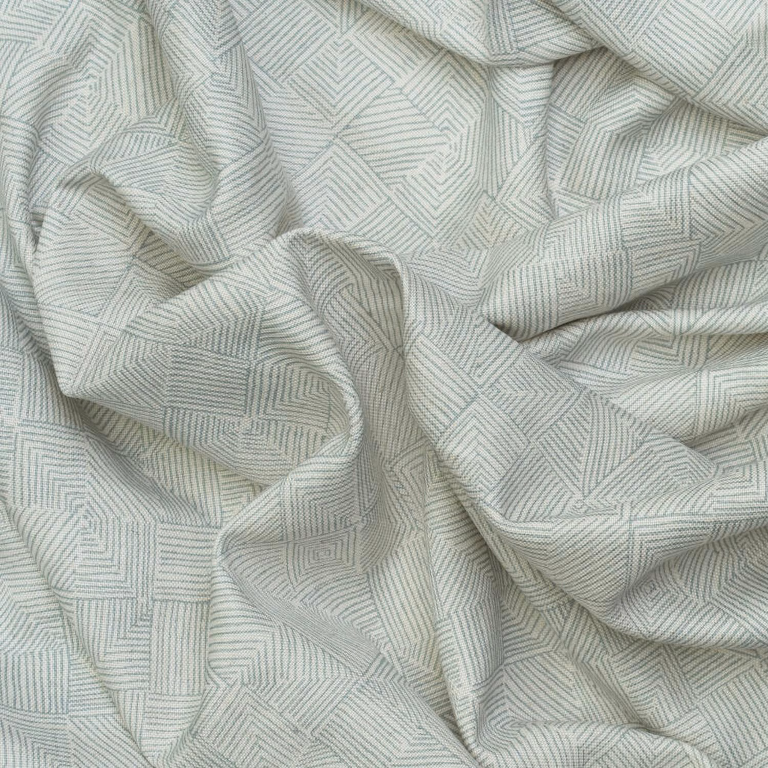 Pale grey-green fabric with fine stepped geometric lines in soft folded folds