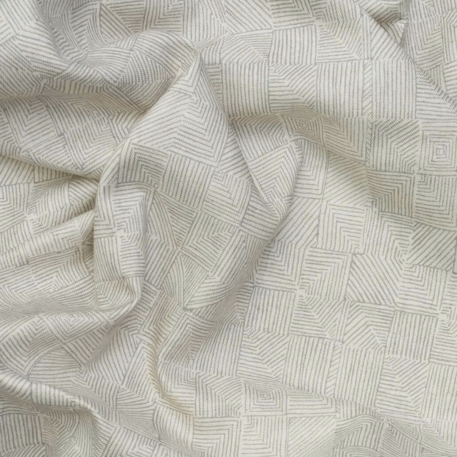 Pale warm-grey fabric with fine nested geometric lines and softly rumpled folds