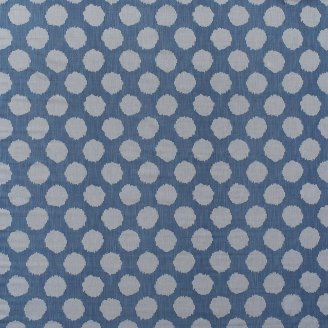 Cool denim-blue cotton print with staggered ivory pebble motifs and subtle vertical texture