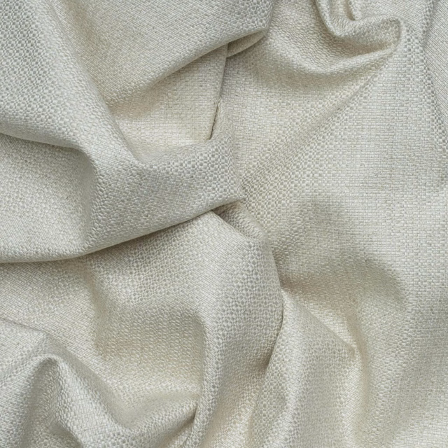Pale greige Birch Stone fabric showing a fine pebbled basket weave in soft folds