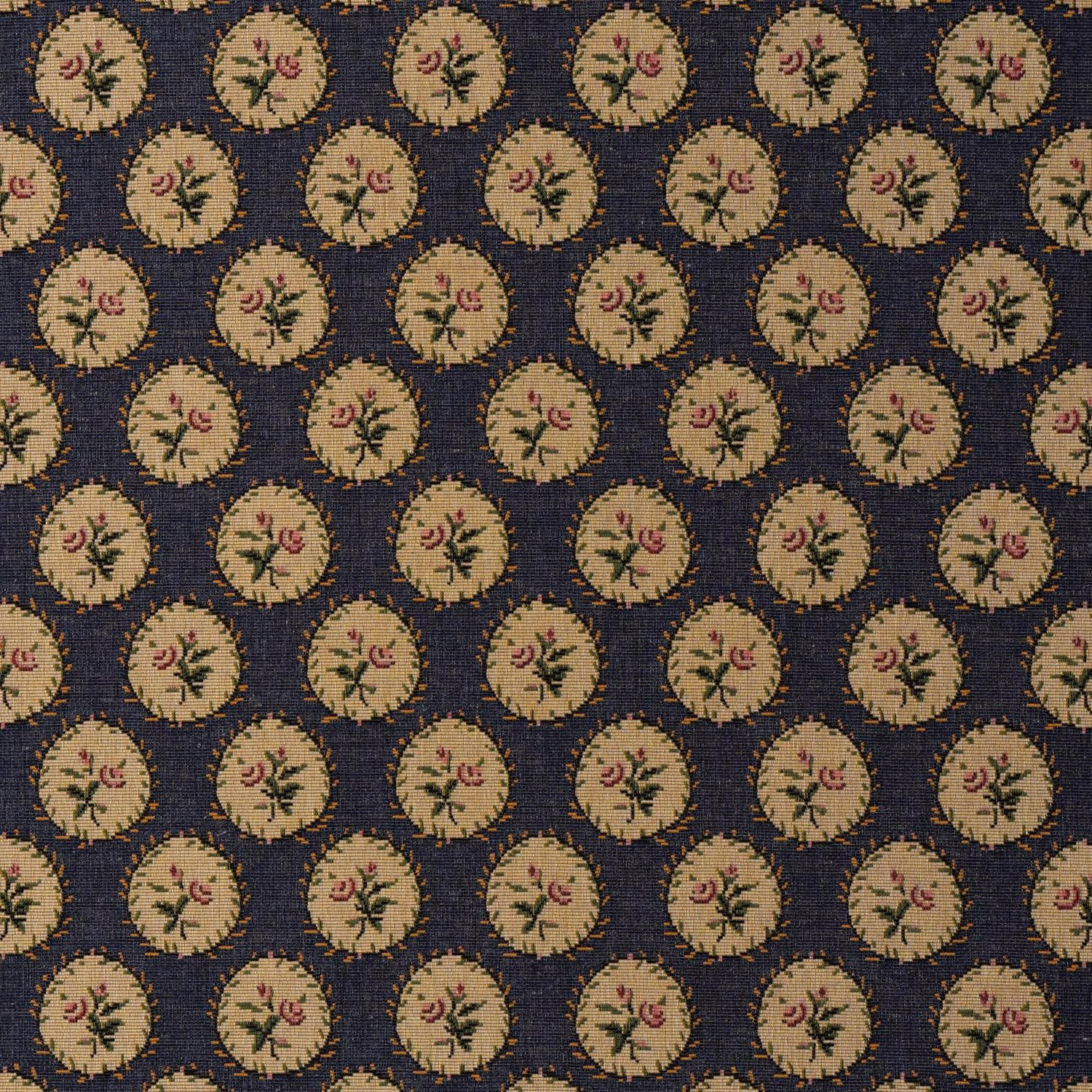 Deep indigo woven ground with repeated beige floral medallions and dusty pink accents
