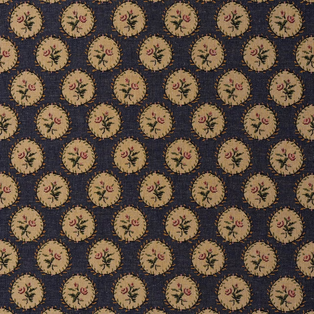 Deep indigo woven ground with repeated beige floral medallions and dusty pink accents