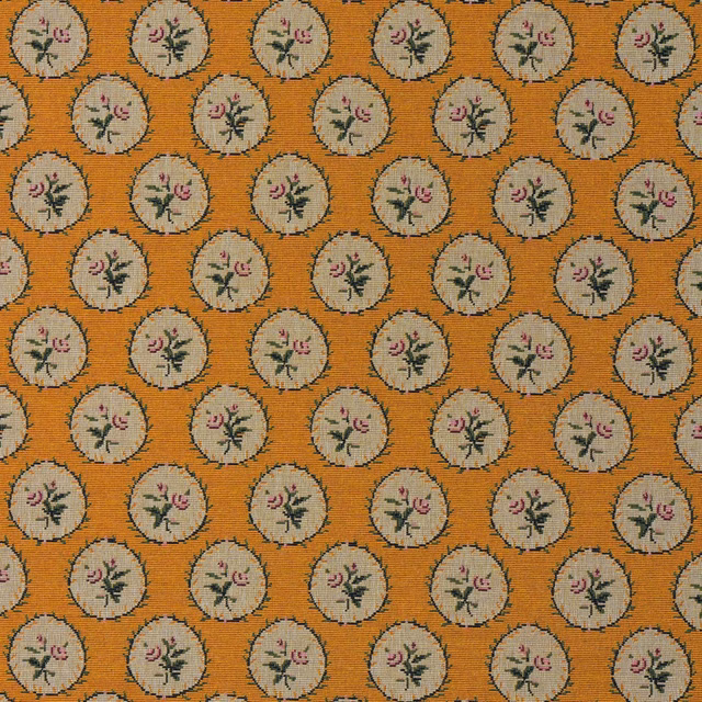Ochre-orange woven ground with cream floral medallions and dusky pink sprigs
