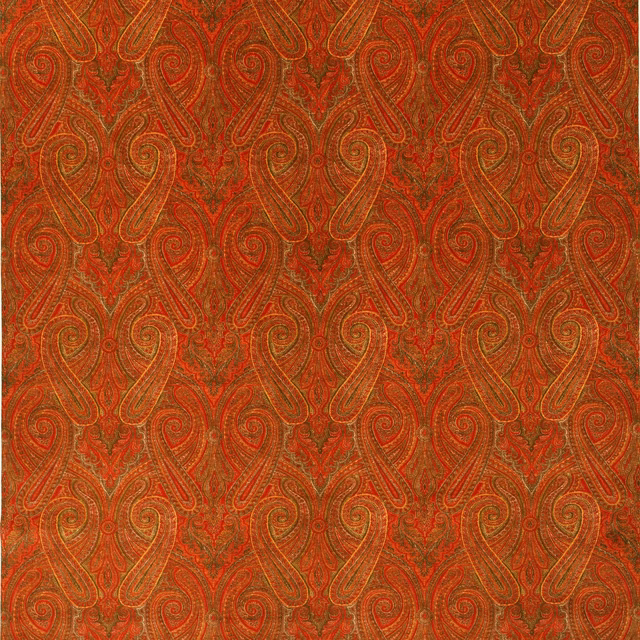 Rust-red velvet swatch with gold and olive paisley curls and fine texture