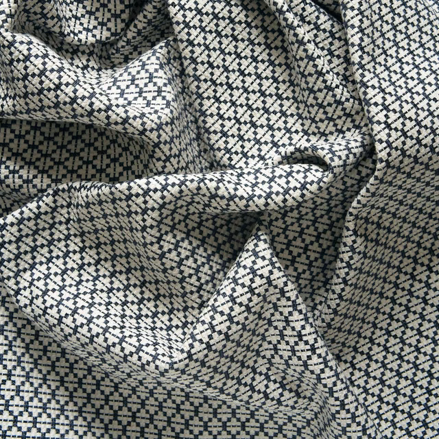 Navy and ivory pixel-check woven fabric gathered into sculptural folds