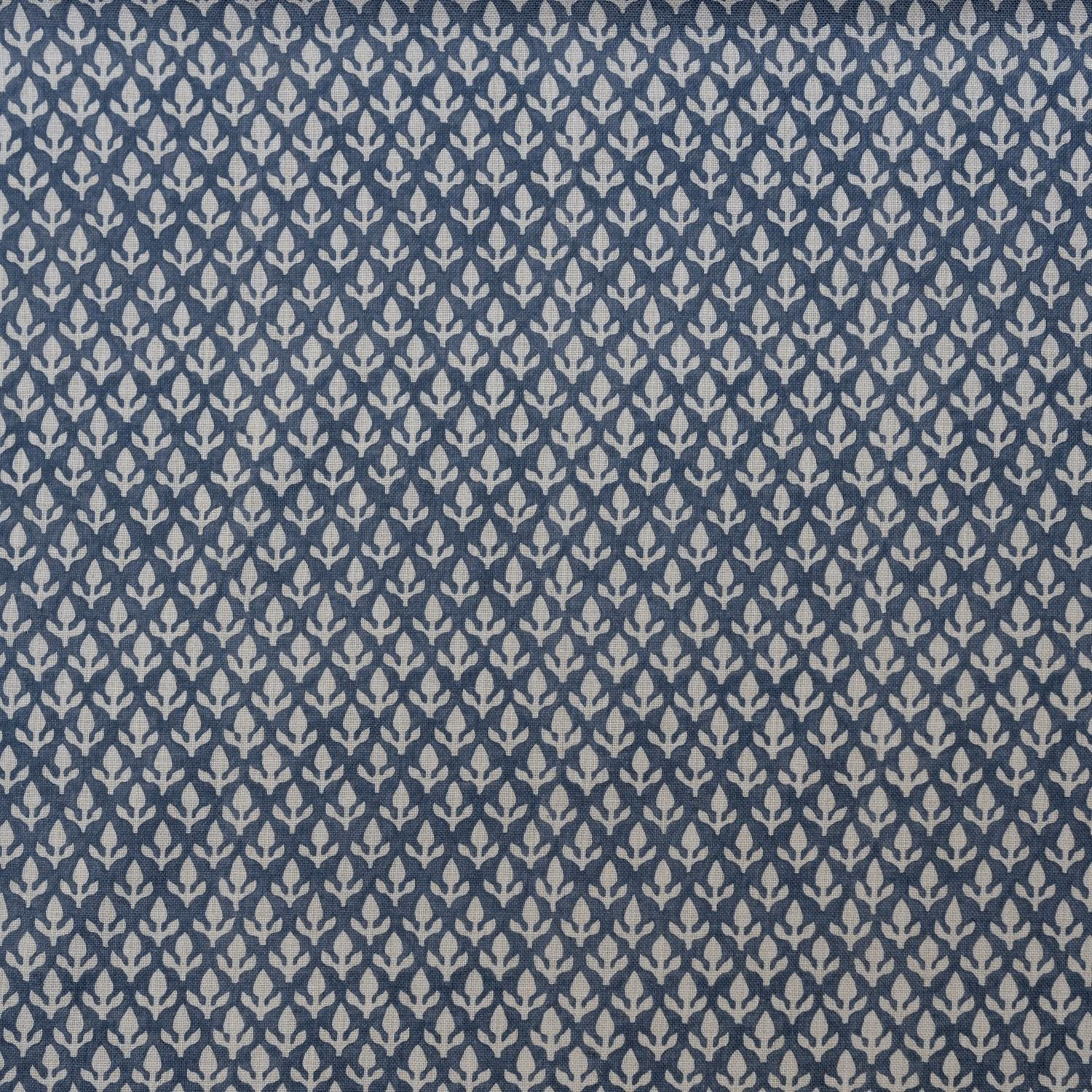Close-up of muted denim-blue weave with dense pale leaf-like motifs