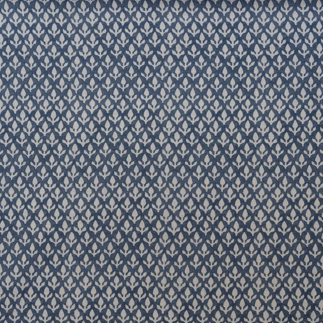 Close-up of muted denim-blue weave with dense pale leaf-like motifs
