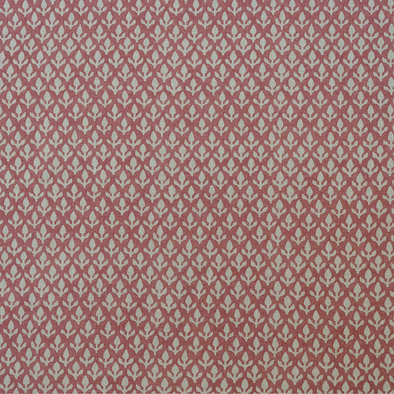 Dusty rose woven fabric with small pale stylised bud motifs in a repeating pattern