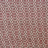 Dusty rose woven fabric with small pale stylised bud motifs in a repeating pattern