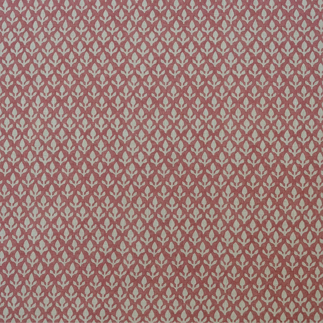 Dusty rose woven fabric with small pale stylised bud motifs in a repeating pattern