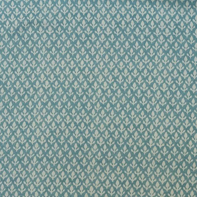 Muted turquoise woven fabric with repeating soft ivory bud motifs