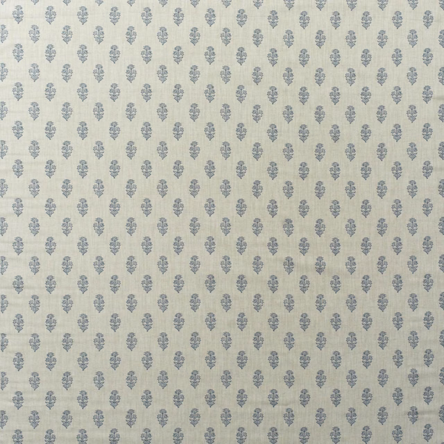 Pale cream cotton print with evenly spaced dusty denim-blue floral motifs