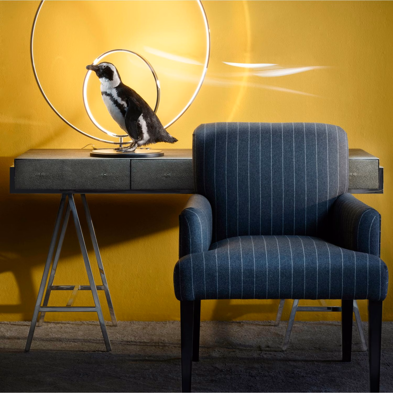 Deep charcoal armchair upholstery with fine pale vertical stripes and subtle woven texture