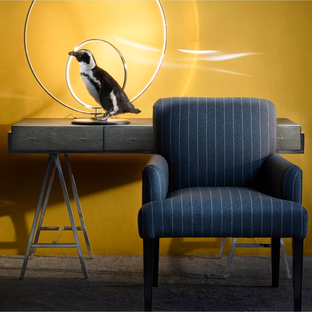 Deep charcoal armchair upholstery with fine pale vertical stripes and subtle woven texture