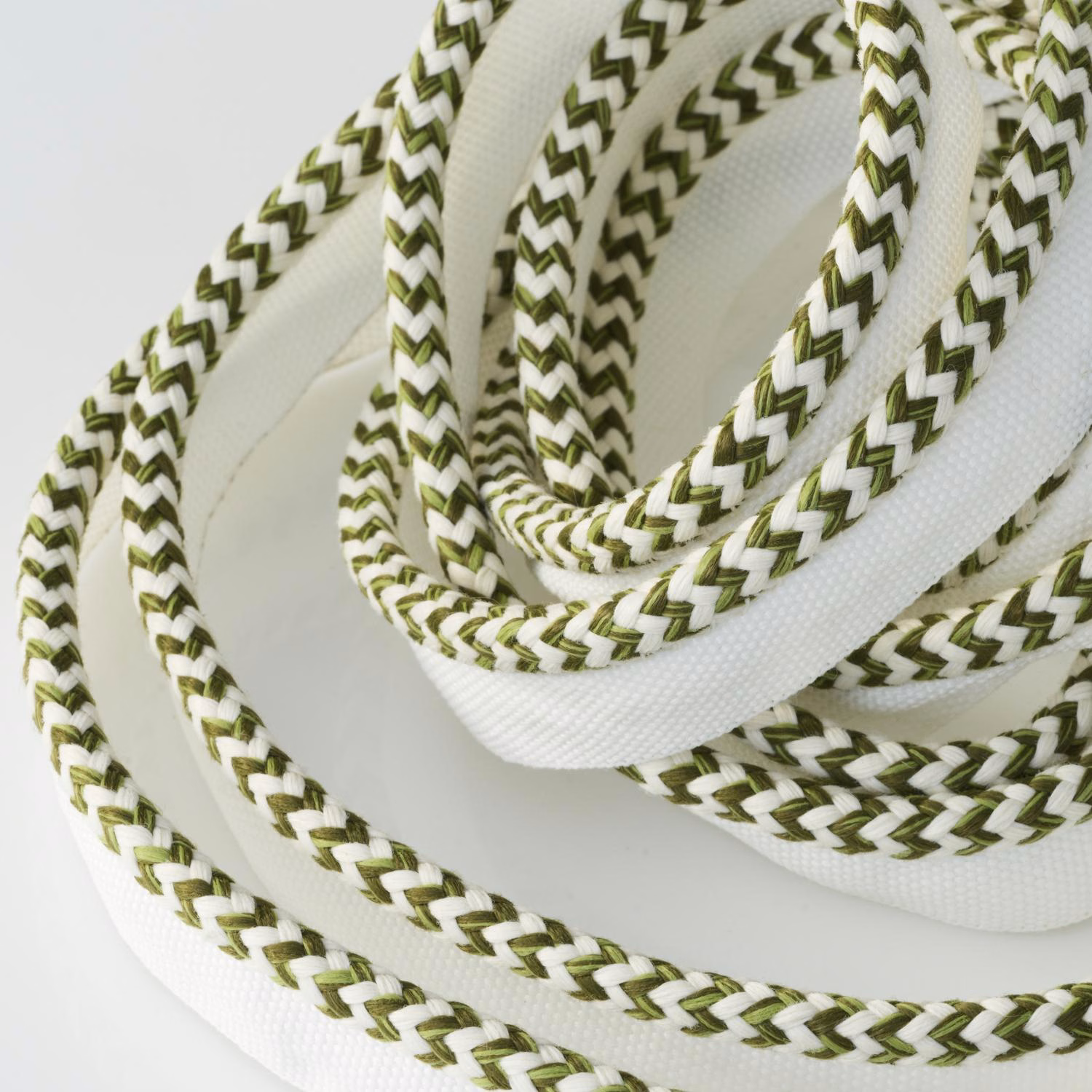 White outdoor trim with olive-green chevron braid and raised corded texture