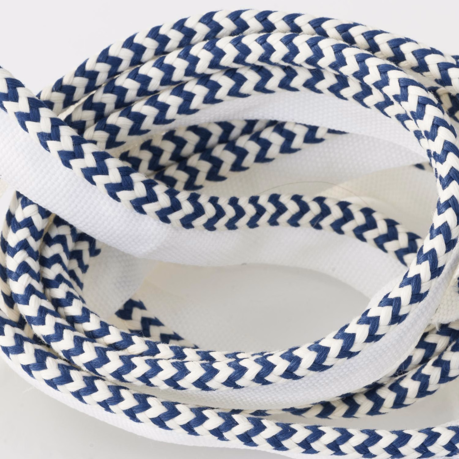 Navy and white braided chevron trim shown in overlapping textured loops