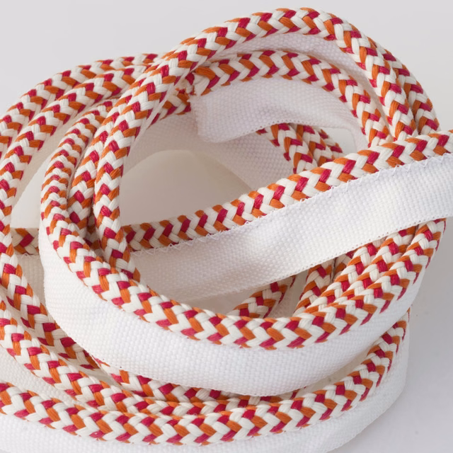 Coiled white outdoor trim with raspberry and ochre braided chevrons