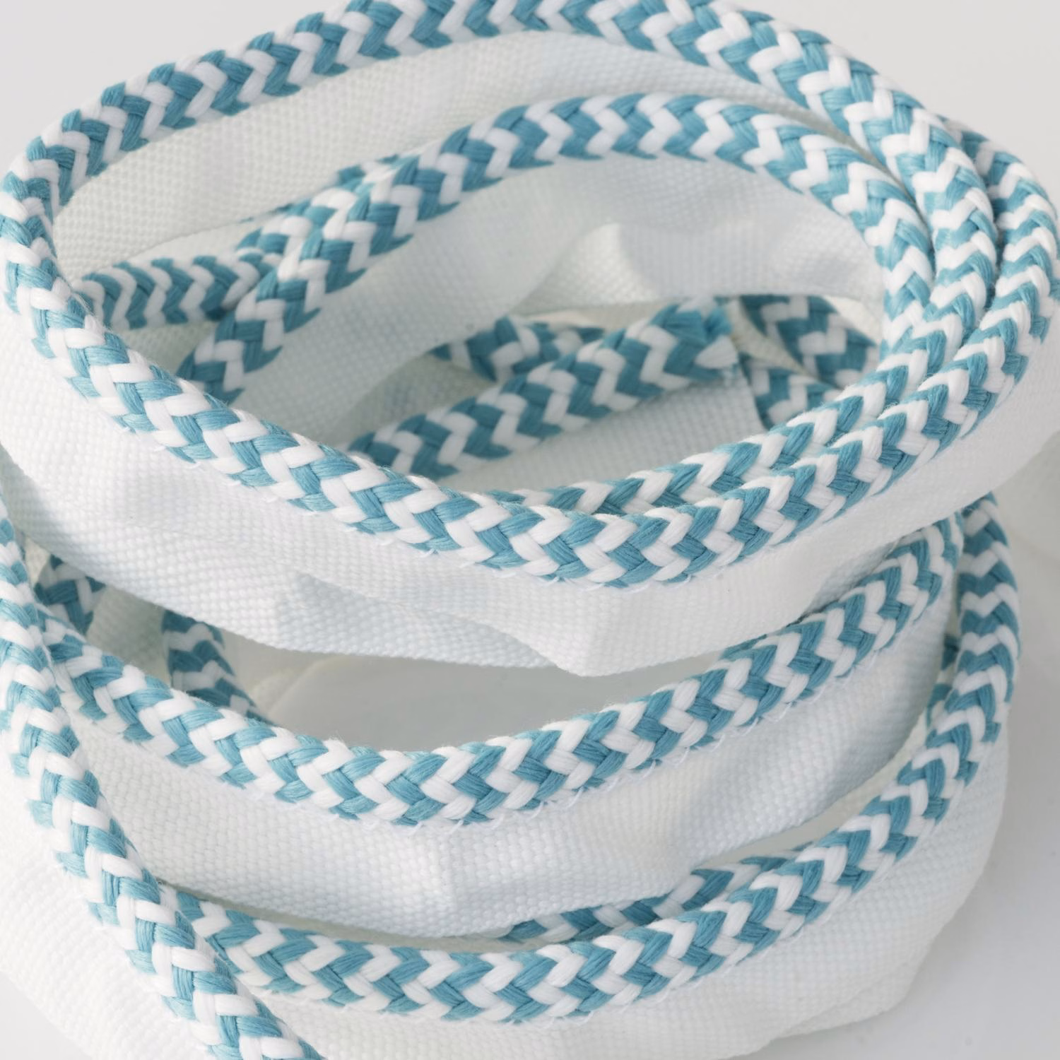 Coiled white trim with pale turquoise and teal braided chevron bands