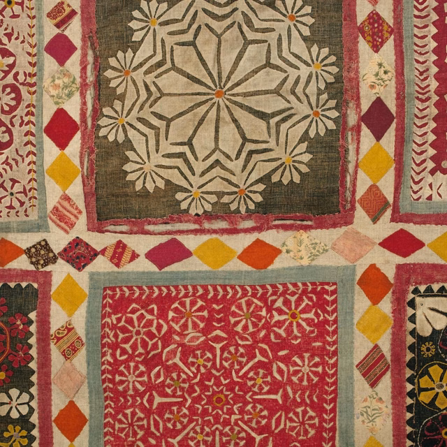 Rust red, ochre and olive patchwork with cream medallion and floral woven motifs