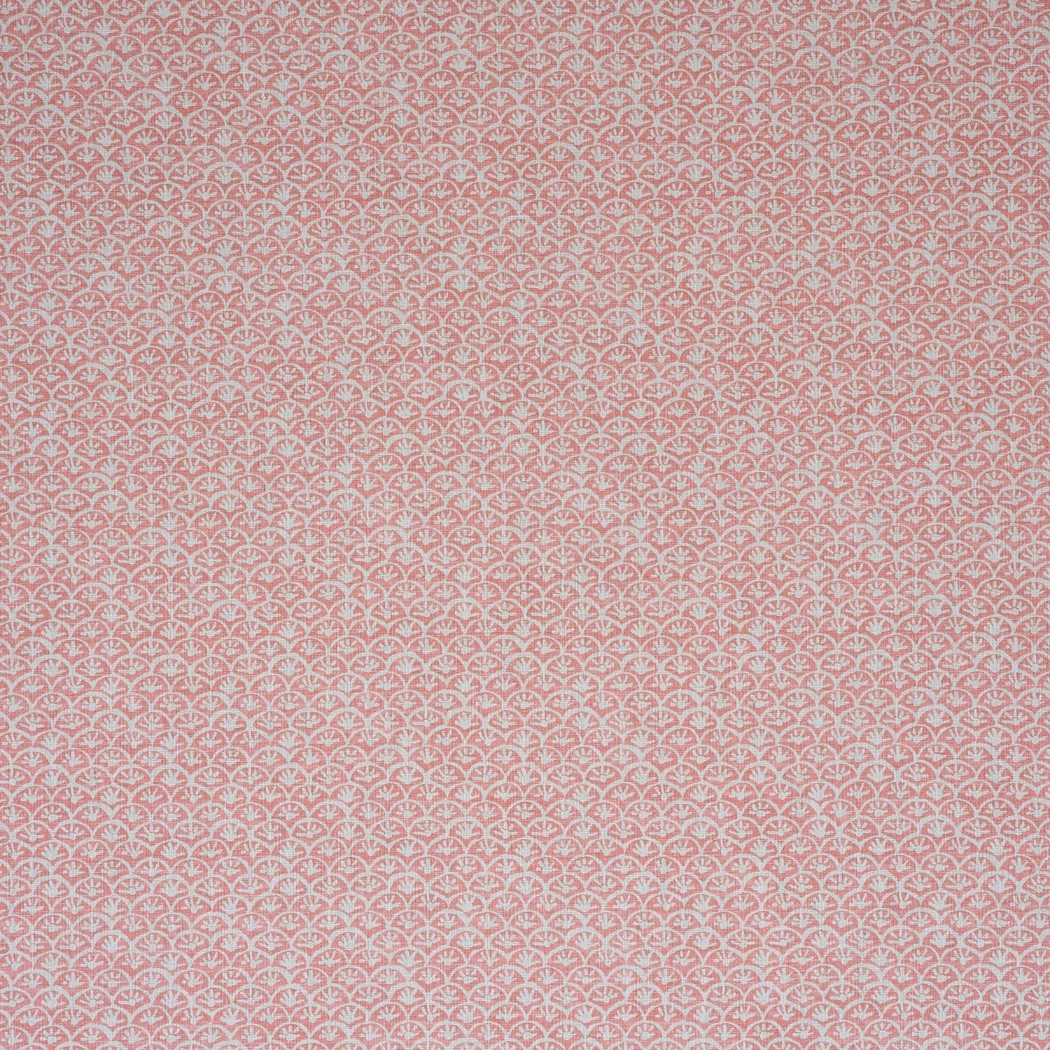 Dusty rose pink fabric with tiny pale scalloped floral motifs in a close repeat