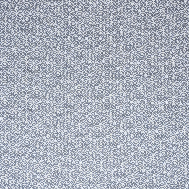 Muted iris-blue fabric with tightly repeated tiny white daisy motifs in rows