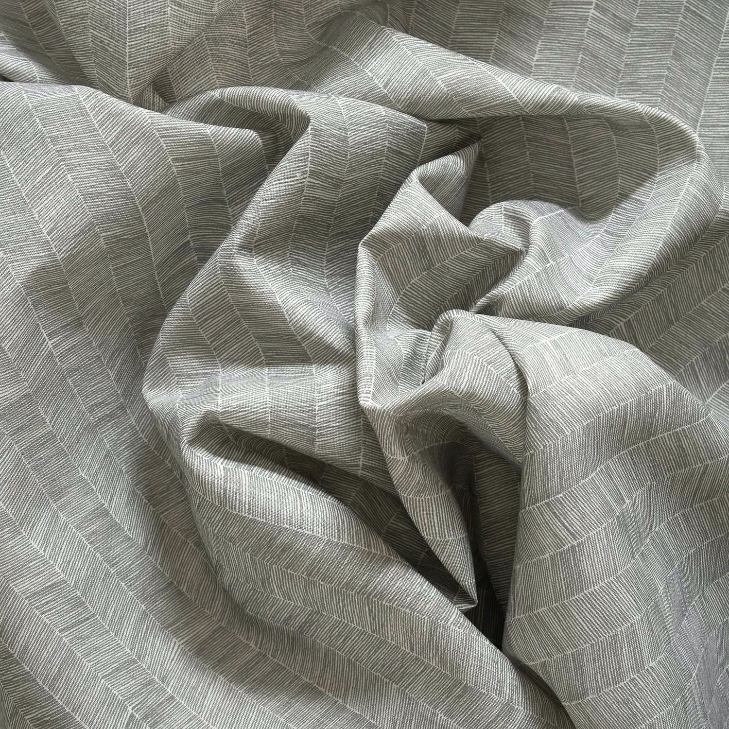 Gathered muted olive-grey outdoor fabric with fine broken linear woven bands