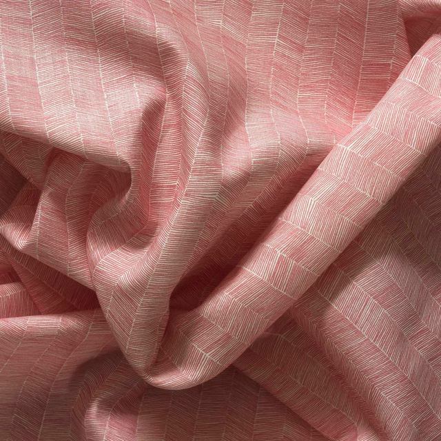 Dusty rose outdoor fabric with fine pale geometric lines and softly textured woven folds