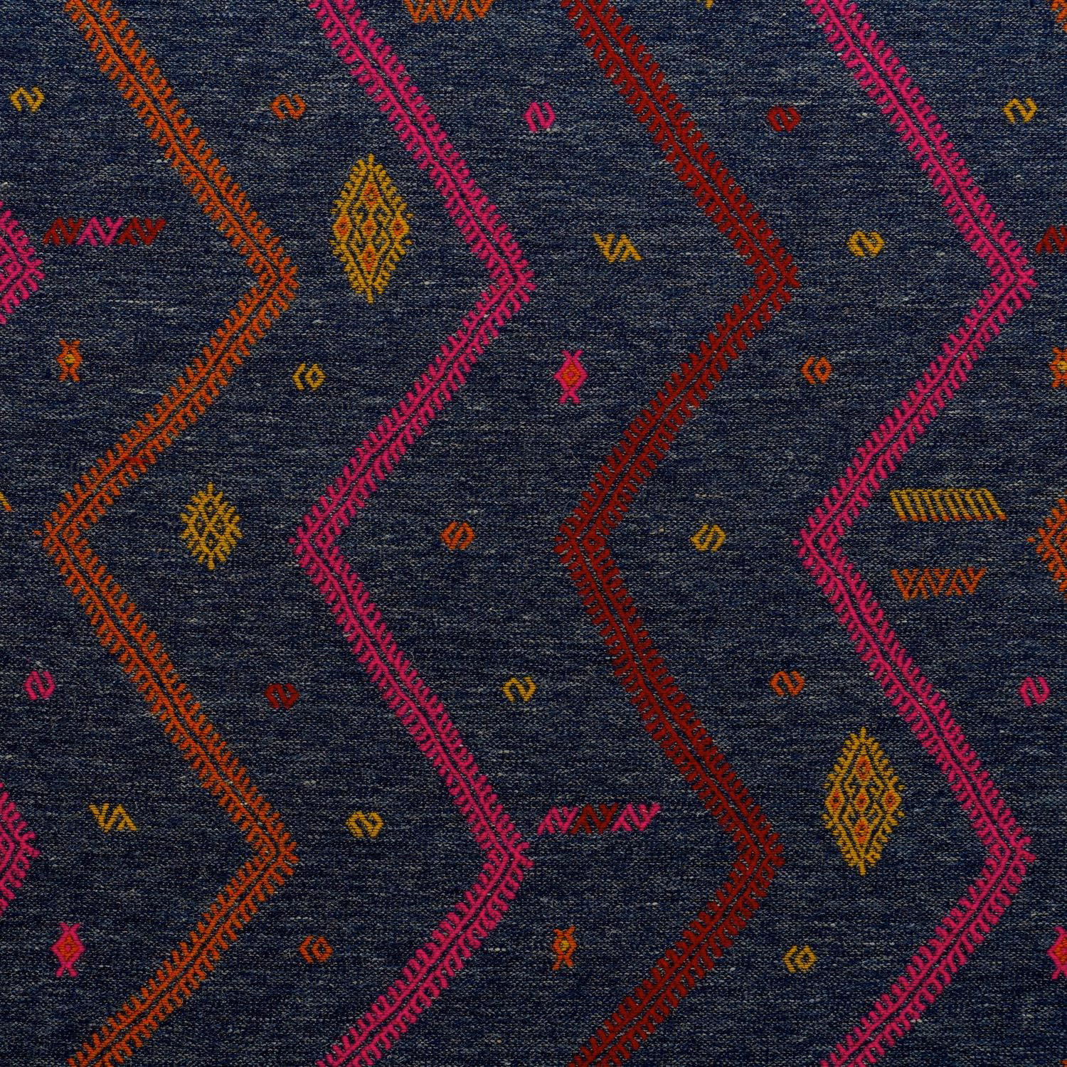 Dark indigo woven ground with magenta, rust and ochre zigzags and motifs