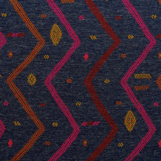 Dark indigo woven ground with magenta, rust and ochre zigzags and motifs