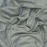 Cool grey boucle cloth with dark broken herringbone diamonds and nubby texture