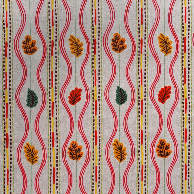 Pale grey woven ground with red waves and multicoloured autumn leaf motifs